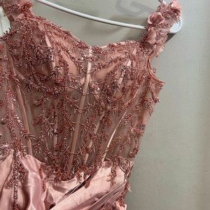 This is a beautiful beaded corset dress with a split in the Color blush.